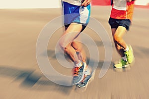 People feet on city road in marathon running race