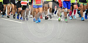 People feet on city road in marathon running race