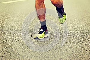 People feet on city road in marathon running race