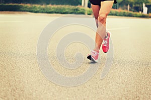 People feet on city road in marathon running race