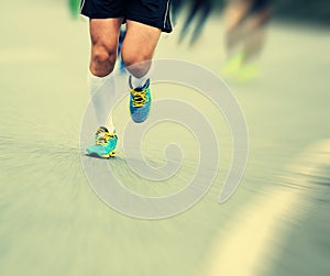 People feet on city road in marathon running race