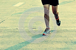 People feet on city road in marathon running race