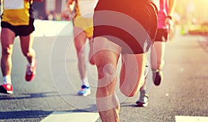 People feet on city road in marathon running race