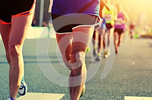 People feet on city road in marathon running race