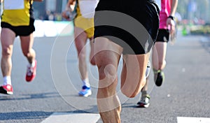 People feet on city road in marathon running race