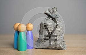 People figurines and chinese yuan or japanese yen money bag.