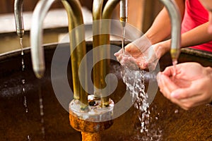 People filling up their hands with mineral water