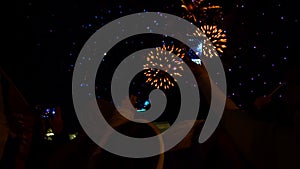 People Filming Fireworks Using Smartphones