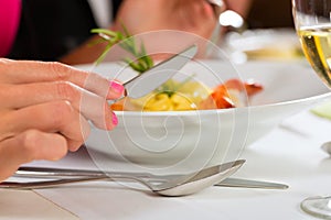 People fine dining in elegant restaurant