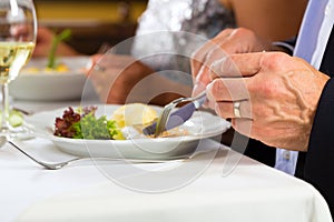 People fine dining in elegant restaurant