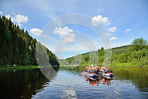 People float down the River on inflatable catamaran