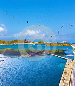 People flying at high zipline on caribbean