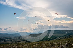 People flying on paraplanes