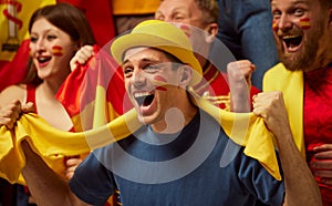 People, football, soccer fans emotionally watching match, cheering up favourite team. Close-up of young man. Fans