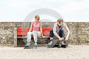 People friends putting on roller skates outdoor