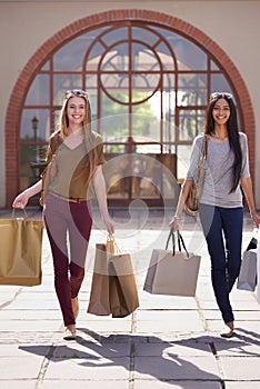 People, friends and shopping bag in city for fashion, sale and discount in a happy portrait. Young women walking and