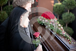 People at Funeral with coffin photo