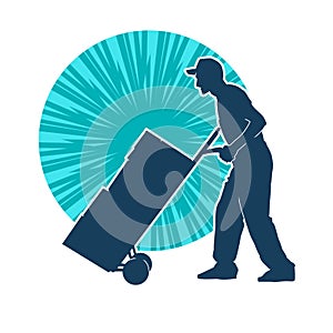 Silhouette of a male worker pushing lori wheels transporting carboard boxes. photo