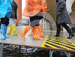 people with gaiters or plastic leggings in Venice Italy