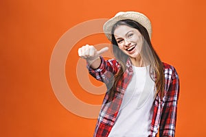 People, gesture, style and fashion concept - happy young woman or teen girl in casual clothes showing thumbs up, isolated over