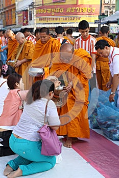 People give food offerings to monks