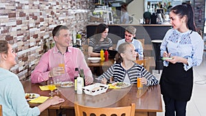 People are giving order to cheerful waitress