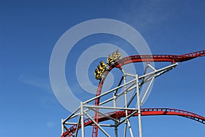 People speeding downhill on a rollercoaster