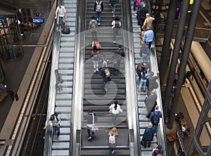People going up and down by the escalator in the main train station.