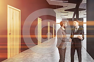 People in gray office hall