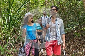People Group With Backpacks Trekking On Forest Path, Mix Race Young Men And Woman On Hike Tourists