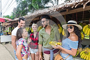 People Group Buying Bananas On Street Traditional Market, Young Man And Woman Travelers