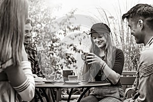 People group drinking latte at coffee bar garden - Friends talking and having fun together at hostel dehors - Lifestyle concept