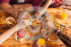 People Group Friends Hands Eating Fast Food Burgers Potato Drinking Orange Juice