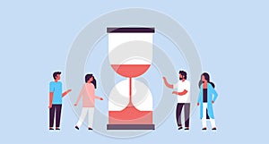 People group standing hourglass time deadline concept on blue background team relationship flat horizontal