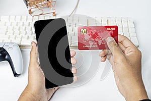 People hand holding credit cards and mobile phones with empty screens for mobile payment, banking, or online shopping