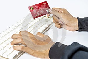 People hand holding credit cards while using computer keyboard for payment, banking, or online shopping