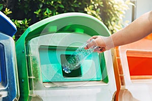 people hand holding garbage bottle plastic putting into recycle bin for cleaning