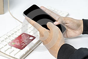 People hand holding mobile phones with empty screens and credit cards for mobile payment, banking, or online shopping