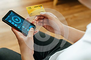 People hand online shopping mobile with mobile smart phone and credit card at home