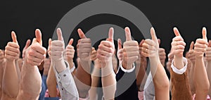 People Hand Showing Thumb Up Sign Against Black Backdrop