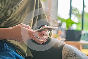 People hand using smartphone with blur cafe shop background