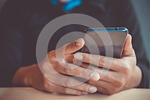 People hand using smartphone with blur cafe shop background