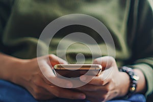 People hand using smartphone with blur cafe shop background