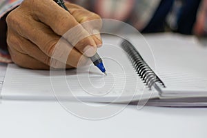 People hand-written notes in a white notebook photo