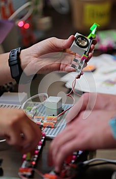 People handle arduino components sonar barcelona vertical photo