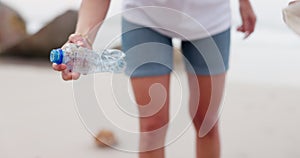 People, hands and beach with bag for recycling plastic bottle, cleaning or saving the planet in nature. Closeup of