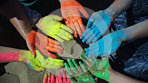 People hands covered in paint at Holi festival