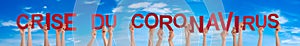 People Hands Holding Word Crise Du Coronavirus Means Corona Crisis, Blue Sky photo