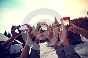 People hands taking pictures of burning sunset sky