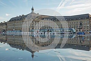 People have fun and refresh on a hot summer day, in the mirror fountain in front of the Place de la Bourse in Bordeaux